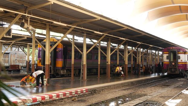 BANGKOK, THAILAND - 11 JULY, 2019: Hua Lamphong railroad station, state railway transport infrastructure SRT. Passengers on platform, people and commuters, trains on tracks. Rail road terminal hub