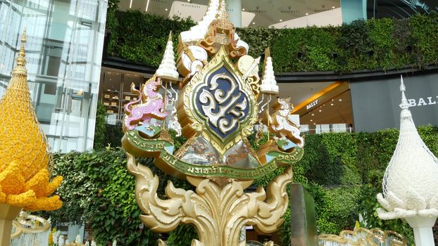 BANGKOK, THAILAND - 11 JULY, 2019: Oriental ornament placed inside mall. Royal family symbolic ornament decorating, green exterior of Siam Paragon shopping mall