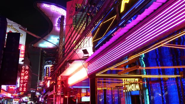 BANGKOK, THAILAND,13 JULY 2019: Vivid neon signs glowing on Soi Cowboy street. Nightlife in erotic Red light district. Illuminated bar and adult go-go show club. Night life tourist entertainment.