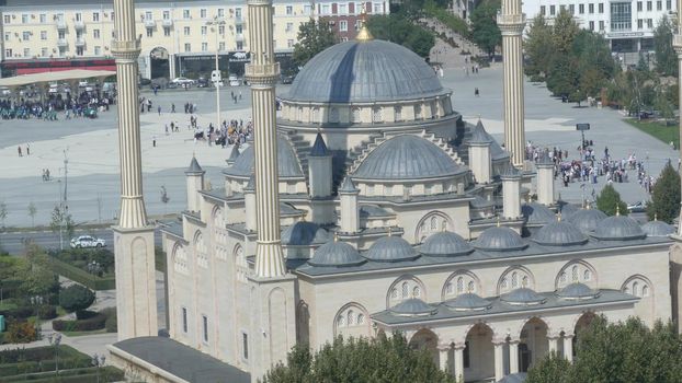 GROZNY, THE CHECHEN REPUBLIC OF ICHKERIA, CAUCASUS, RUSSIA - 6 SEPTEMBER 2019: Day of Civil Concord and Unity celebration in capital near The Heart of Chechnya. People on square near islamic mosque