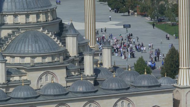 GROZNY, THE CHECHEN REPUBLIC OF ICHKERIA, CAUCASUS, RUSSIA - 6 SEPTEMBER 2019: Day of Civil Concord and Unity celebration in capital near The Heart of Chechnya. People on square near islamic mosque