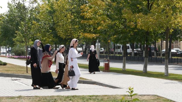 GROZNY, THE CHECHEN REPUBLIC OF ICHKERIA, CAUCASUS, RUSSIA - 6 SEPTEMBER 2019: Day of Civil Concord and Unity celebration, capital, The Heart of Chechnya. Happy cheerful young muslim people on square