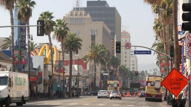 LOS ANGELES, CALIFORNIA, USA - 7 NOV 2019: Walk of fame promenade, Hollywood boulevard in LA city. Pedastrians walking on sidewalk of street. Entertainment and cinema industry iconic tourist landmark.