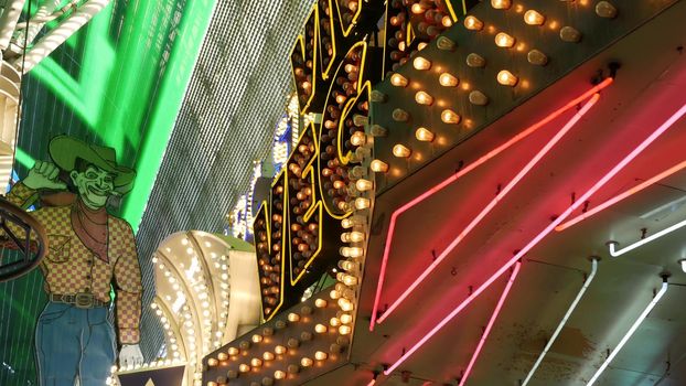 LAS VEGAS, NEVADA USA - 12 DEC 2019: Cowboy Vegas Vic, old neon sign glowing, Freemont street in sin city. Illuminated retro welcoming signboard to Pioneer Club casino. Vintage greeting man at night.