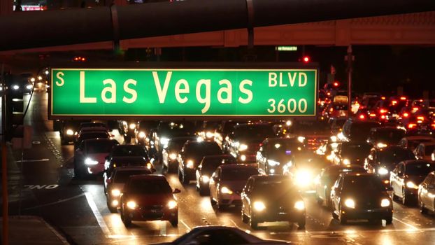 LAS VEGAS, NEVADA USA - 13 DEC 2019: Traffic sign glowing on The Strip in fabulous sin city. Iconic signboard on the road to Fremont street. Illuminated symbol of casino, money playing and betting.