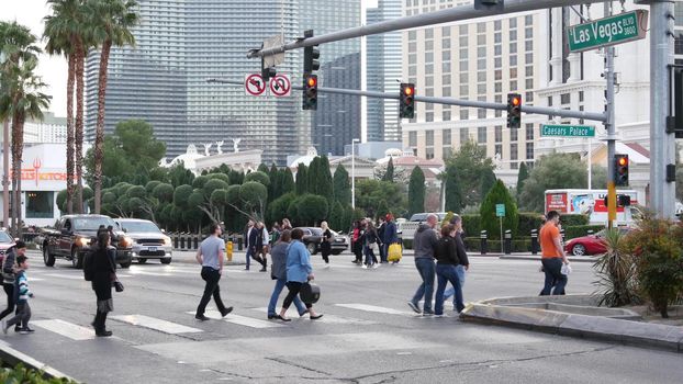 LAS VEGAS, NEVADA USA - 13 DEC 2019: People on pedestrian walkway. Multicultural men and women walking on city promenade. Crowd of citizens on sidewalk. Diversity of multiracial faces in metropolis.