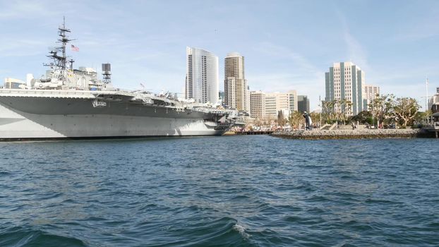 SAN DIEGO, CALIFORNIA USA - 30 JAN 2020: USS Midway military aircraft carrier, historic war ship. Naval army battleship. Maritime warship, legend of navy fleet near Unconditional Surrender Statue.