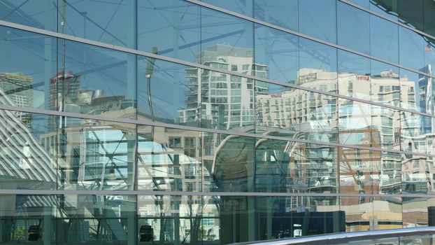 SAN DIEGO, CALIFORNIA USA - 13 FEB 2020: Contemporary Convention Center building, reflection of urban skyline in mirror glass wall. Highrise skyscrapers of Gaslamp Quarter in downtown of metropolis.