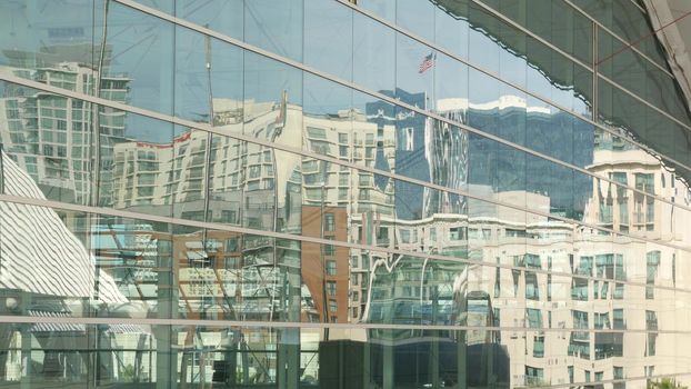 SAN DIEGO, CALIFORNIA USA - 13 FEB 2020: Contemporary Convention Center building, reflection of urban skyline in mirror glass wall. Highrise skyscrapers of Gaslamp Quarter in downtown of metropolis.