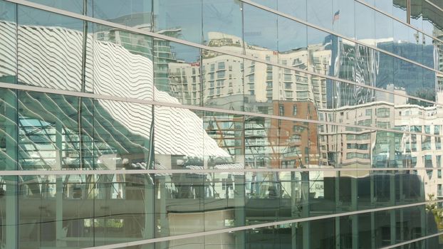 SAN DIEGO, CALIFORNIA USA - 13 FEB 2020: Contemporary Convention Center building, reflection of urban skyline in mirror glass wall. Highrise skyscrapers of Gaslamp Quarter in downtown of metropolis.