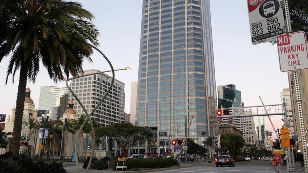 SAN DIEGO, CALIFORNIA USA - 13 FEB 2020: Pedestrians, traffic and highrise buildings in city downtown. Street life of american metropolis. Urban Broadway street, transport and citizens near Santa Fe.