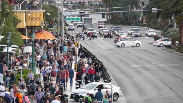 LAS VEGAS, NEVADA USA - 5 MAR 2020: People on pedestrian walkway. Multicultural men and women walking on city promenade. Crowd of citizens on sidewalk. Diversity of multiracial faces in metropolis.