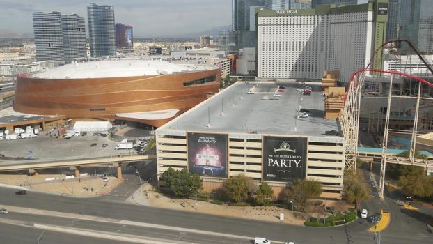 LAS VEGAS, NEVADA USA - 7 MAR 2020: Sin city in Mojave desert from above. Traffic highway in valley with arid climate. Aerial view of road in tourist metropolis. Gambling and betting area with casino.