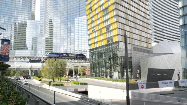 LAS VEGAS, NEVADA USA - 7 MAR 2020: Futuristic CityCenter casino complex in sin city. Modern luxury unincorporated urban skyline. Contemporary metropolis highrise skyscraper and monorail express train