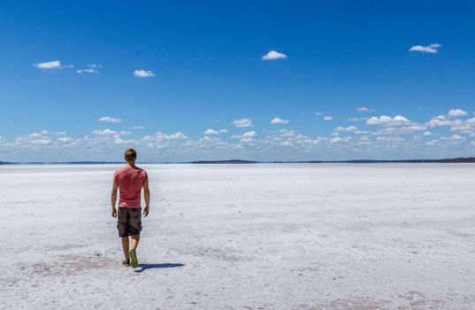 time to relax for a man walking on a salt lake in western
