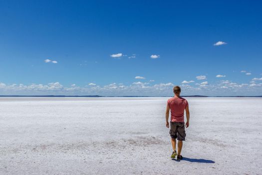 time to relax for a man walking on a salt lake in western