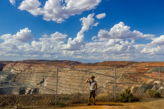 young man at the lookout of the australian gold mine - super pit in Kalgoorlie