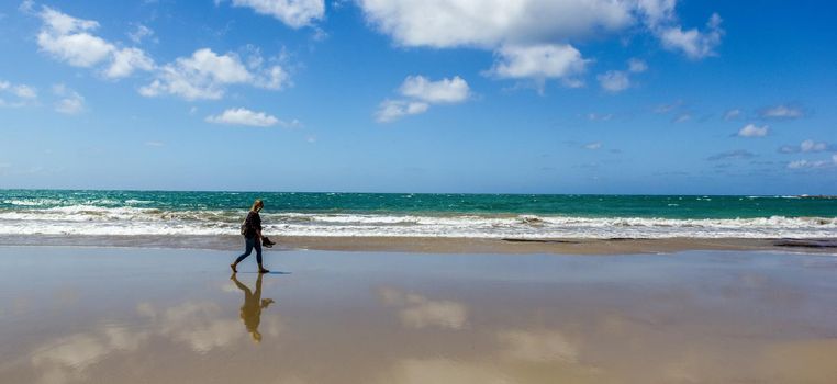 Young woman walk on an empty wild beach, Great Ocean Road, Australia