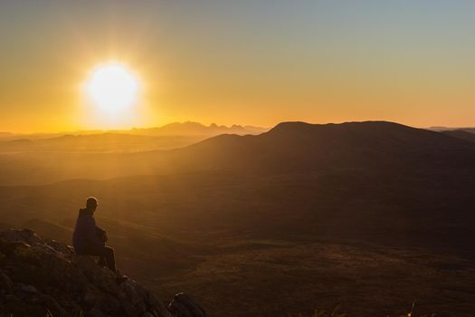 Hiker at the top of Mount Gillen just outside Alice Springs in central Australia.