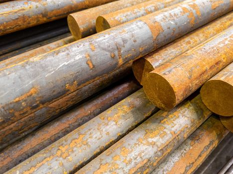 rusted long round steel bars pack - close-up with selective focus and background blur