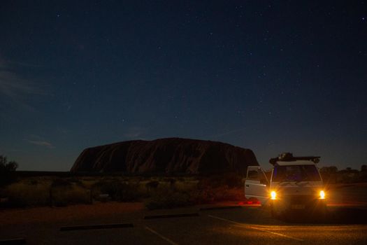 Uluru at night with car in front, ayers Rock, the Red Center of Australia