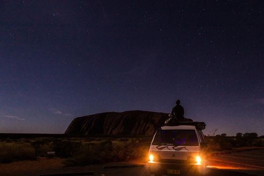 Uluru at night with car in front, ayers Rock, the Red Center of Australia