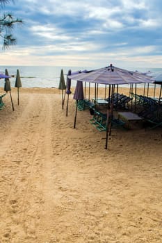 Colorful canvas daybed under the beach umbrella