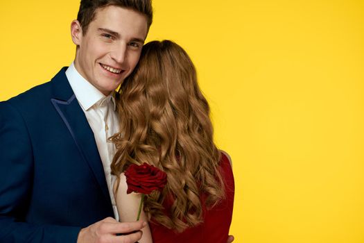 Cute couple dating hug romance yellow background. High quality photo
