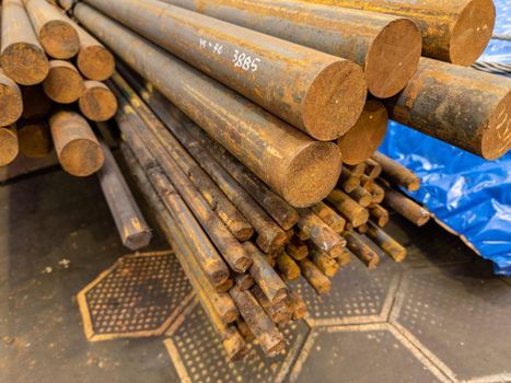 rusted round steel bars pack ends - close-up with selective focus and background blur
