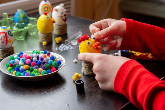 A child makes a gift egg for the Easter holiday