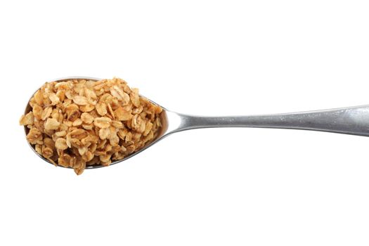 Top view of a silver spoon with granola oats on white