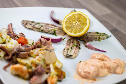 appetizer with seafood goblet of wine and cutlery on wooden background
