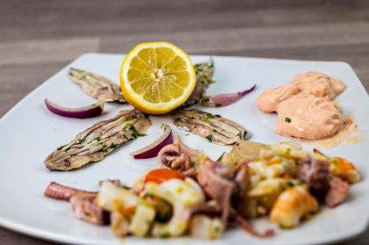appetizer with seafood goblet of wine and cutlery on wooden background