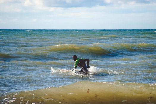 Zelenogradsk, Russia. A lone surfer trains on small waves in the Baltic sea