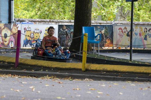 terni,italy august 16 2020:child at the park going on the electric car track