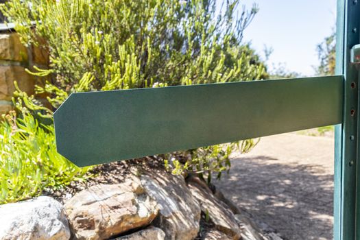 Green turquoise empty place name or direction sign in Kirstenbosch, Cape Town.