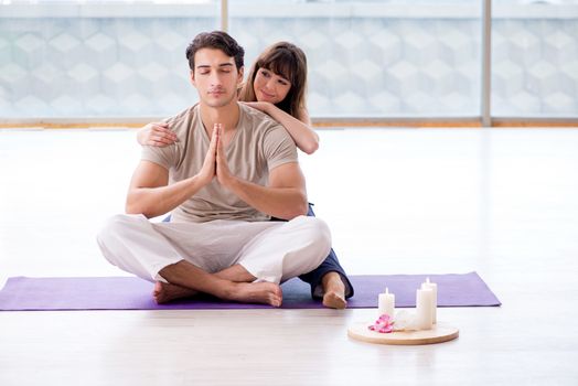 Personal coach helping during yoga session