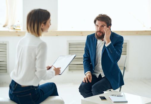 A man in a suit at a psychologist's office near the window. High quality photo