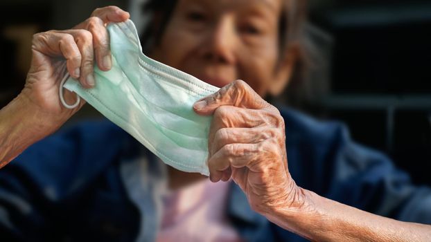 Elderly woman wearing a mask to protect from coronavirus covid-19