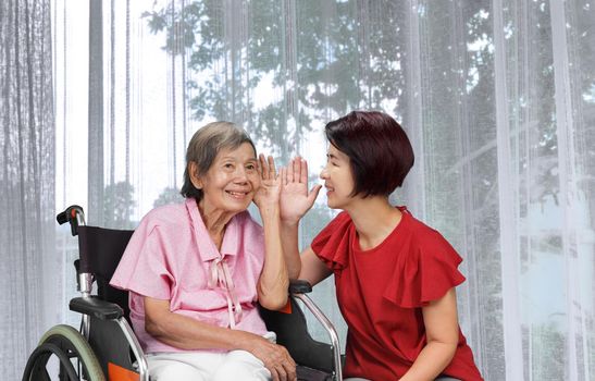 Asian seniors woman hearing loss , Hard of hearing try to talk with daughter.