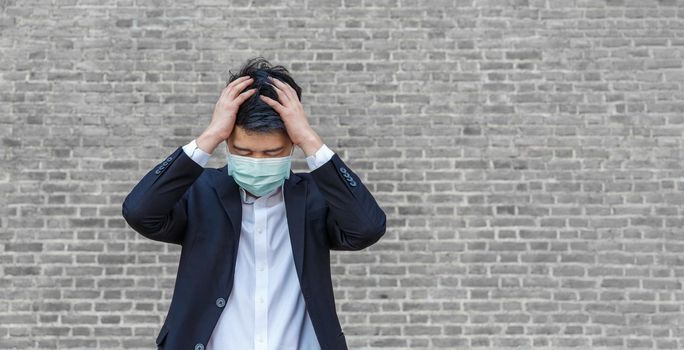 Business man in distress of job losses due to COVID-19 virus pandemic