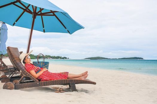 Middle aged woman relaxing at chaweng beach in koh samui ,Thailand.