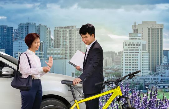 Car Free Day. Business man and woman using bike instead car in the city