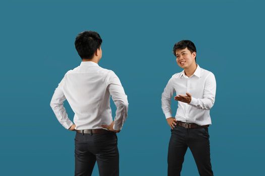 Two employee having a confrontation ,  isolated on blue background