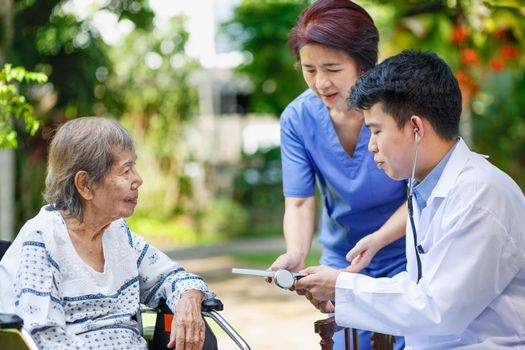 Doctor checking lung of elderly woman during homecare medical