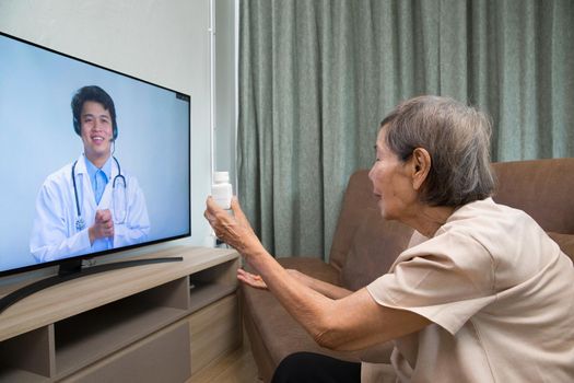 Elderly woman sit at home having online consultation with doctor