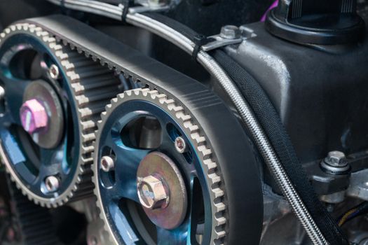 Timing belt and twin camshaft sprocket in engine racing car.