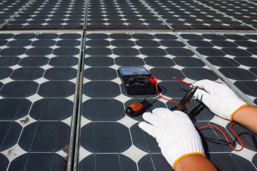 Technician repairing photovoltaic modules (Solar panels) in rural