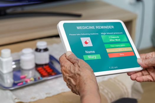 Senior adult use medical reminder app to help keep her safe and in control