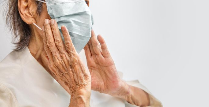 Elderly woman wearing a mask to protect from coronavirus covid-19